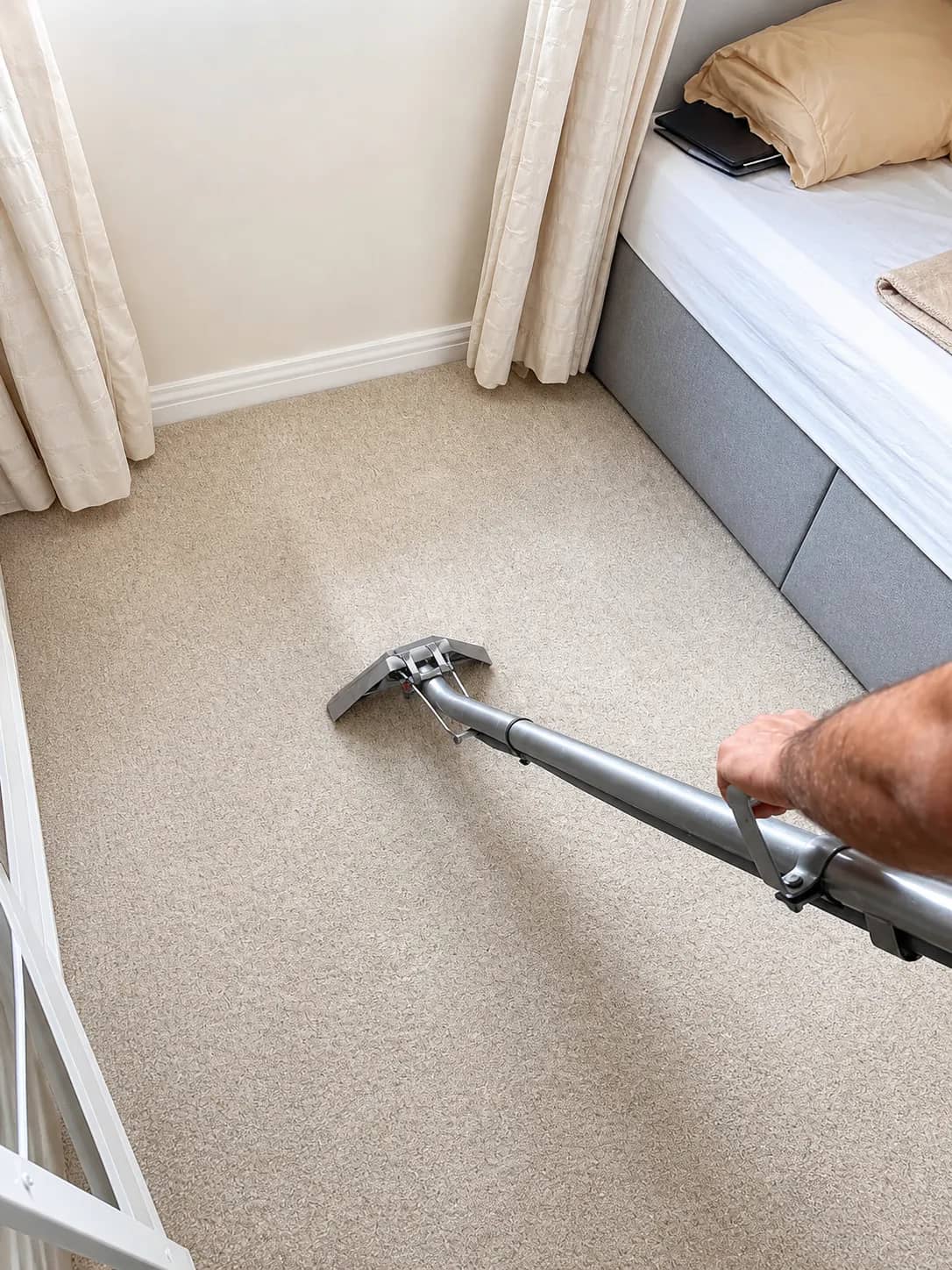 Light carpet being cleaned near a radiator